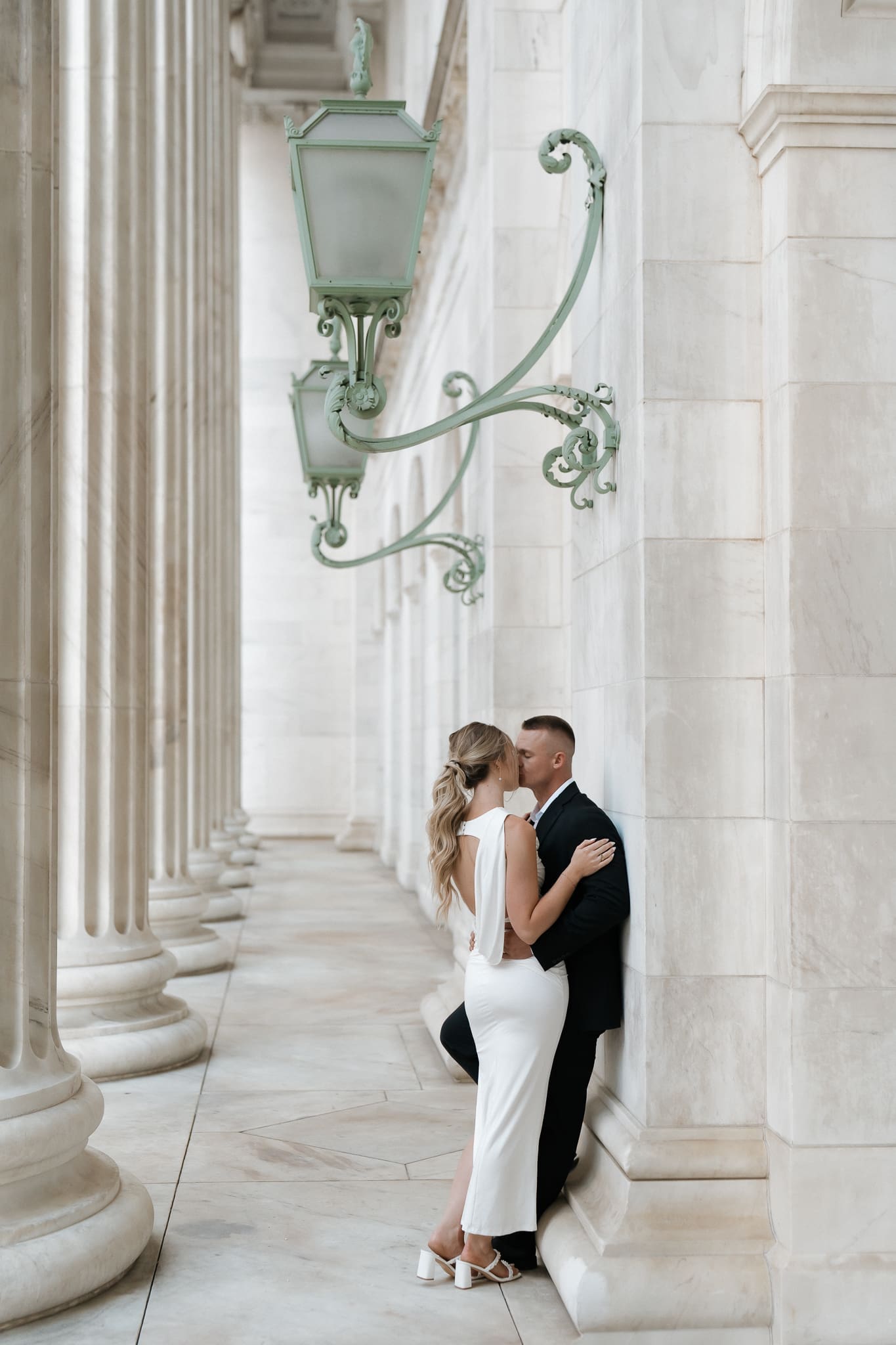Romantic courthouse wedding portraits beside the white marble columns in Denver