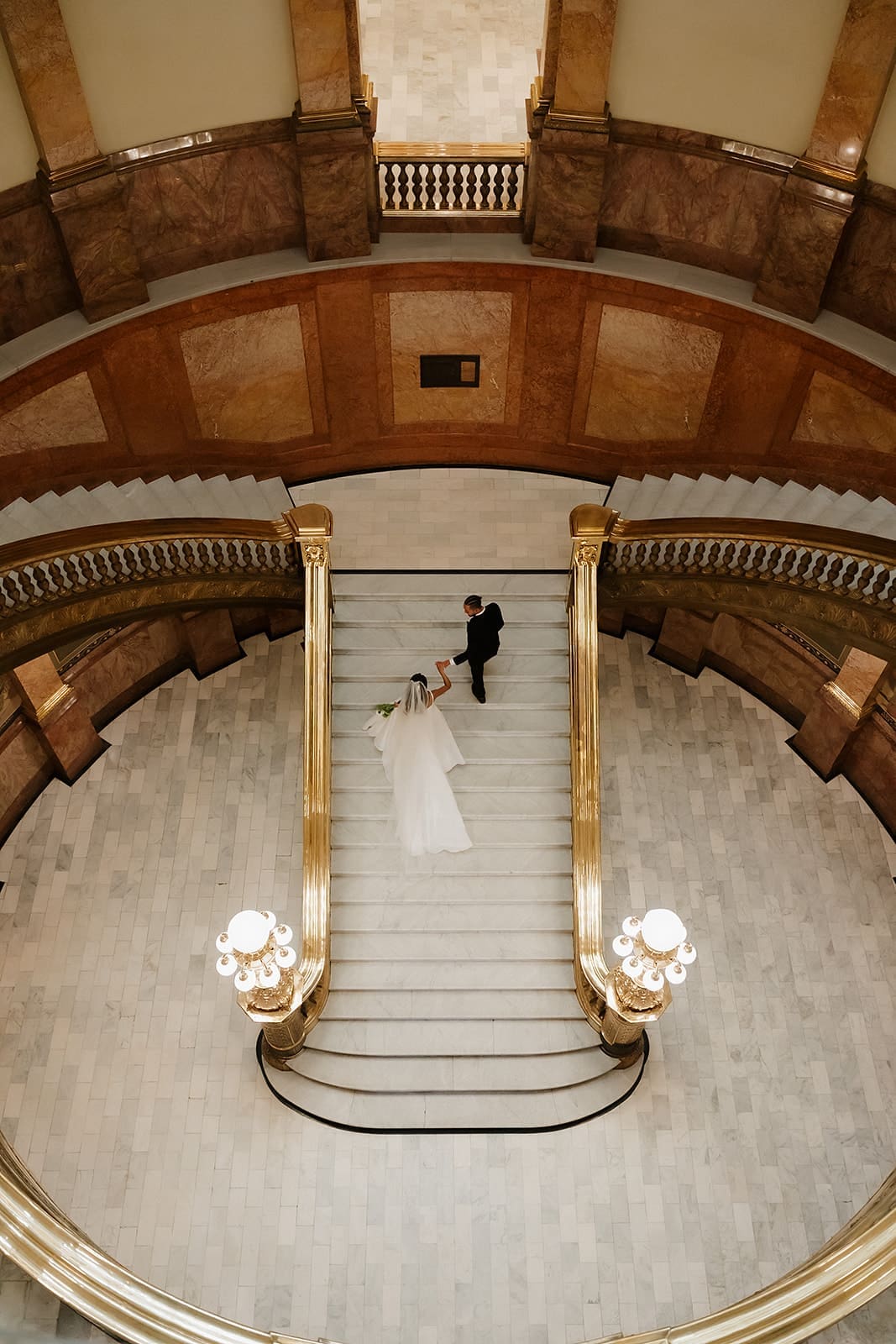 Overhead view of a couple during their Denver elopement at the Colorado State Capitol staircase
