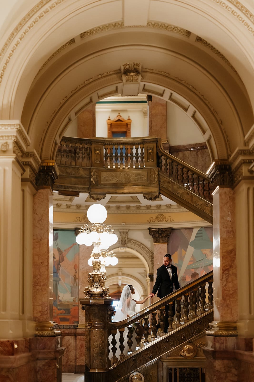 Elegant bride and groom portraits on the grand marble staircase at the Colorado State Capitol