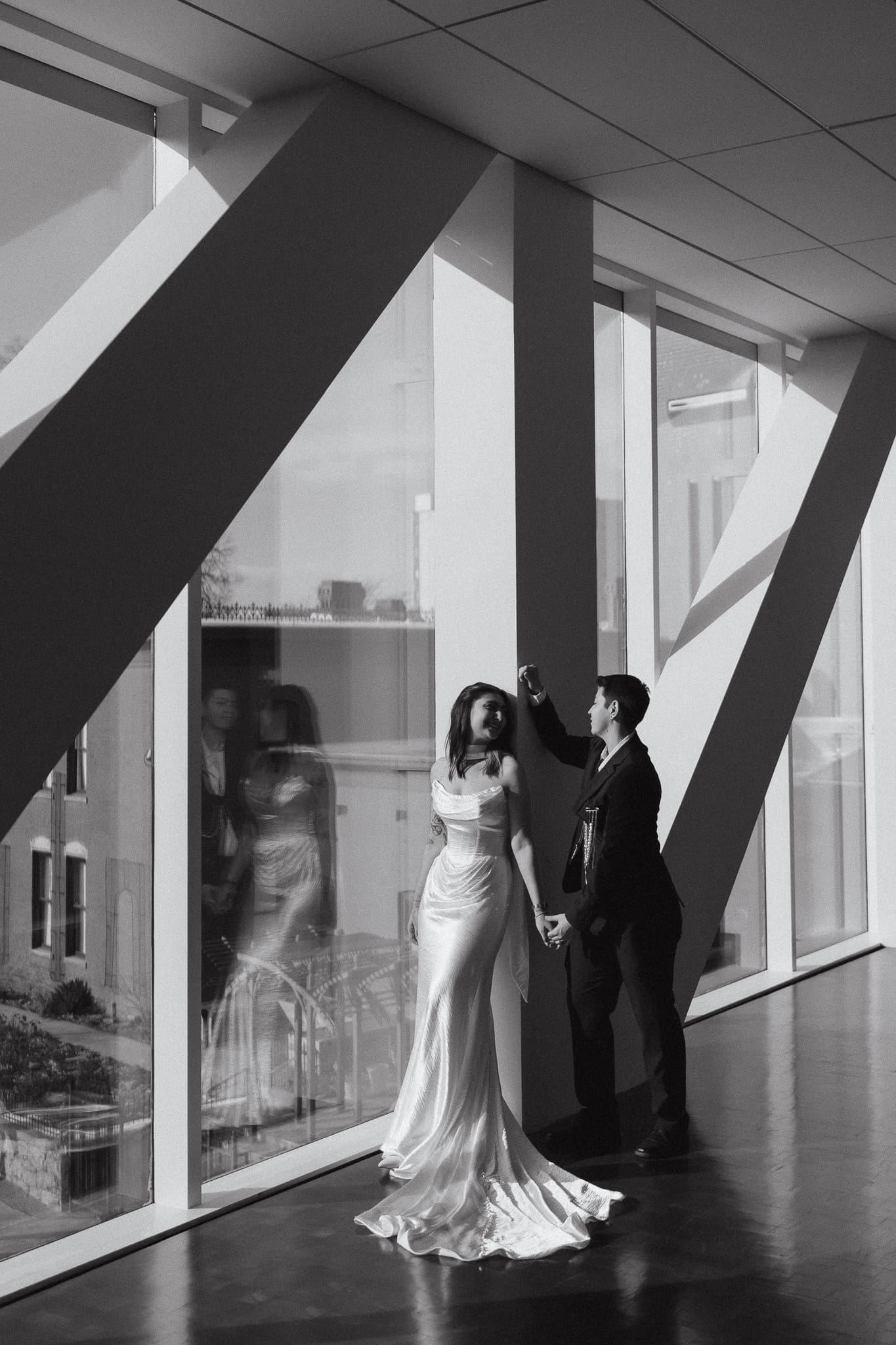 Black and white editorial wedding portraits inside the Denver Art Museum walkway