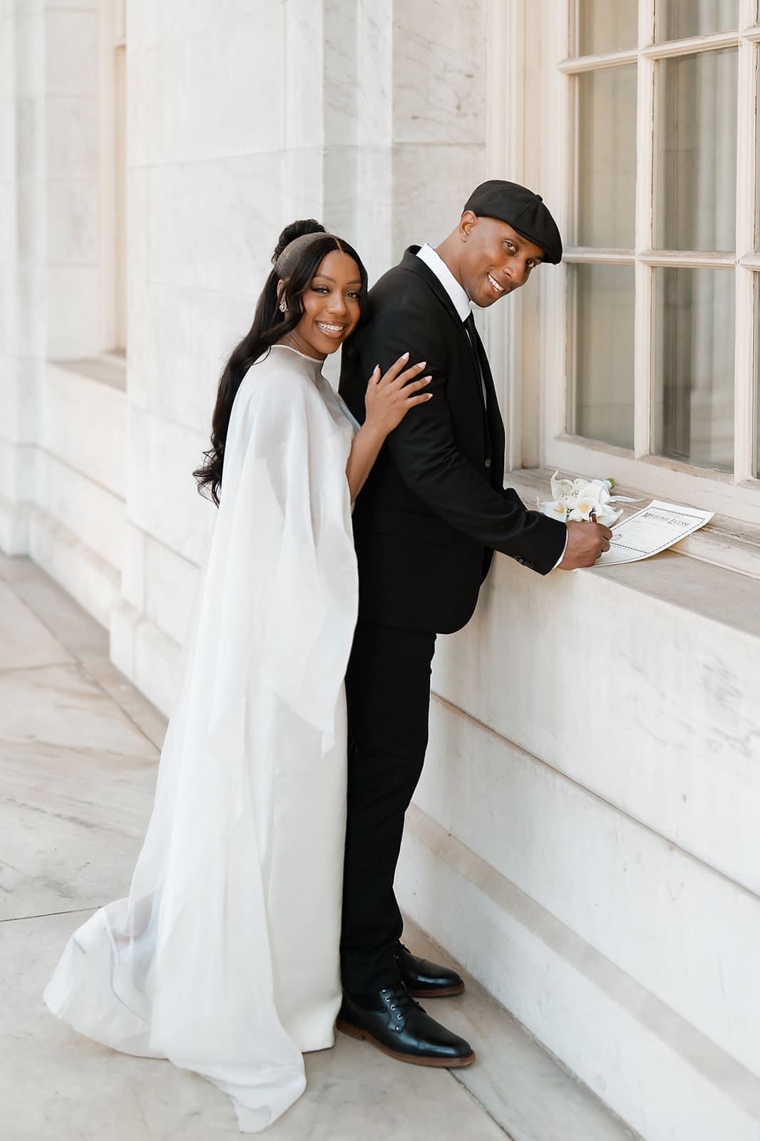 Couple signing their marriage license during an intimate courthouse ceremony
