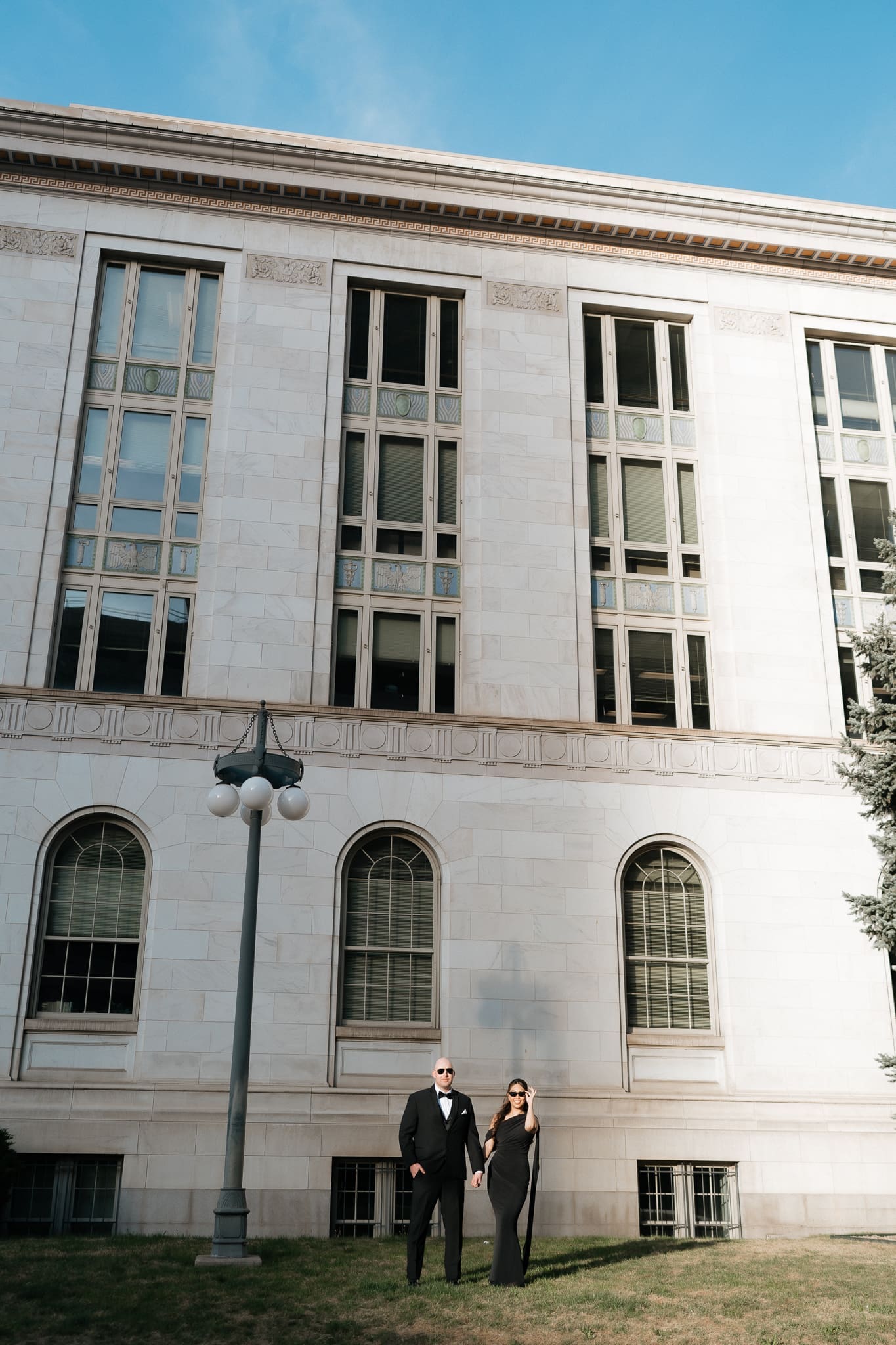 Stylish couple portraits outside a downtown Denver courthouse with modern city architecture