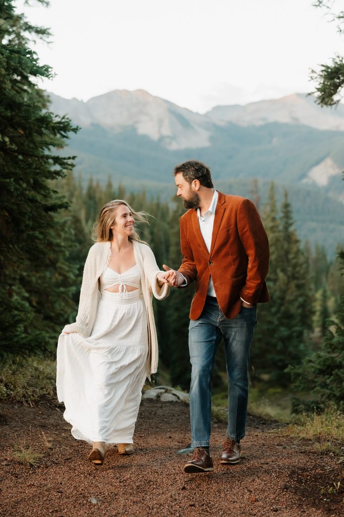 Colorado Engagement Session Locations Engaged couple holding hands with mountain views in Crested Butte during their Colorado engagement session