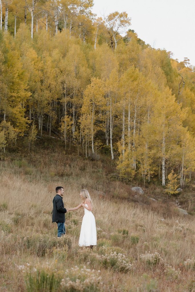 Colorado Engagement Session Locations Couple posing among golden aspen trees near Vail during Kylie and Luke's Colorado engagement session