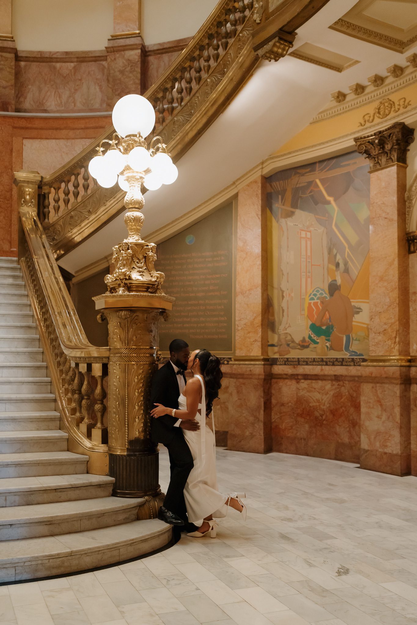 Colorado Engagement Session Locations Couple posing on a grand staircase during their downtown Denver Colorado engagement session