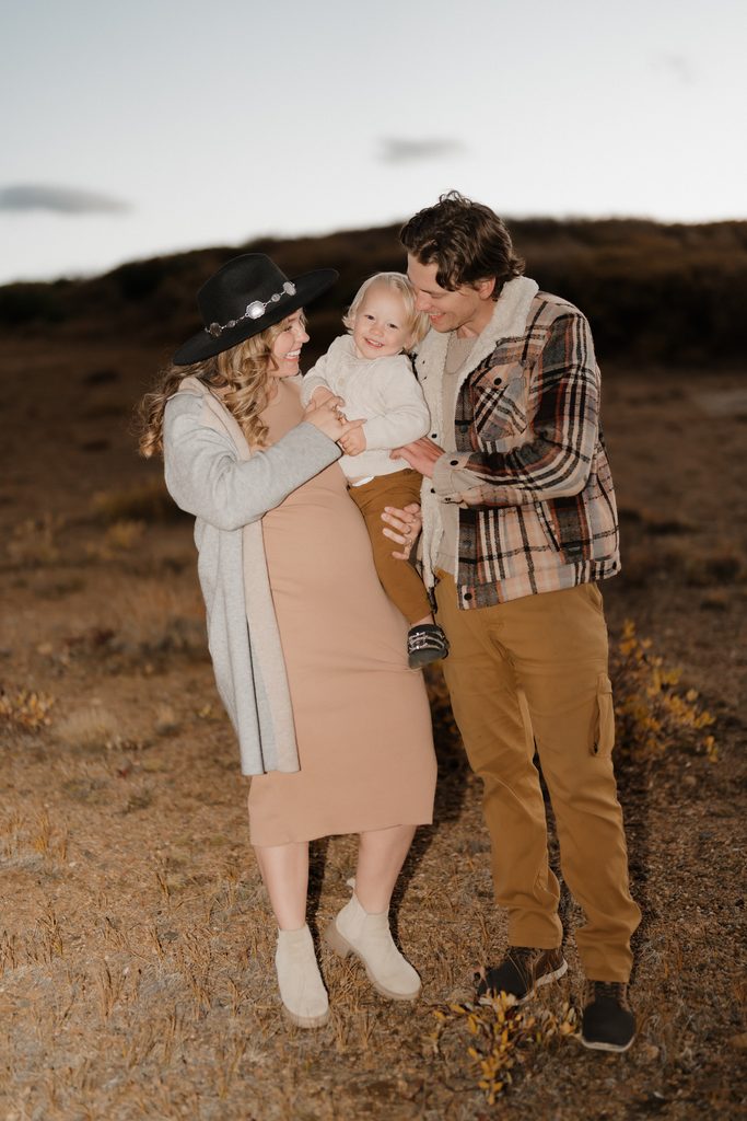 Colorado Engagement Session Locations Couple with their baby enjoying mountain views during their Guanella Pass Colorado engagement session