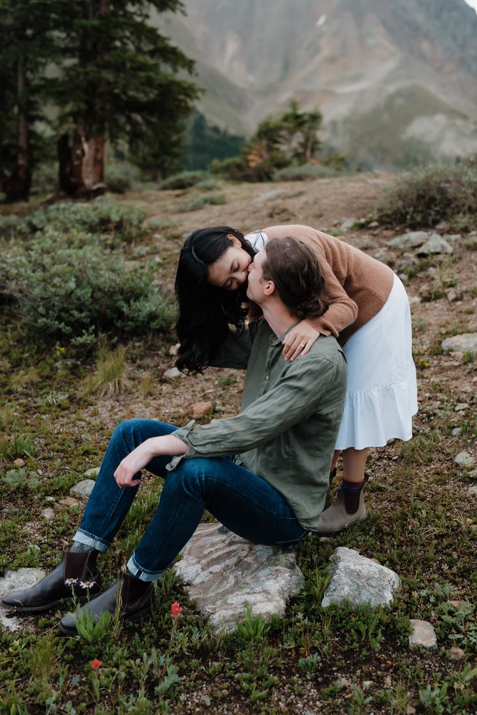 Colorado Engagement Session Locations Couple laughing together in a mountain meadow during their Loveland Pass Colorado engagement session