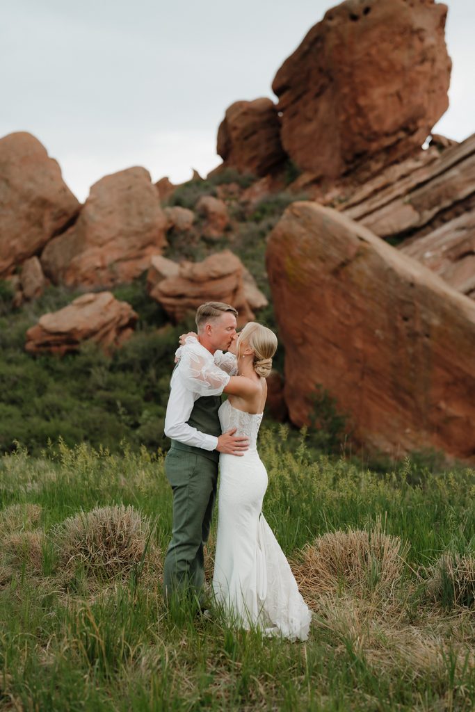 Colorado Engagement Session Locations Couple embracing among red rock formations during their Red Rocks Colorado engagement session