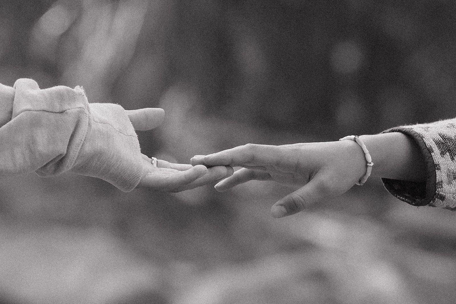 Rocky Mountain National Park elopement detail shot of couple reaching for each other in black and white